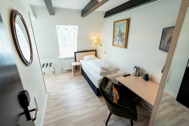 Standard single room, small bathroom, note stairs to floor