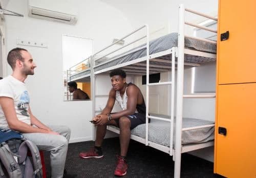 Bed in 8-Bed Male Dormitory Room with Shared Bathroom
