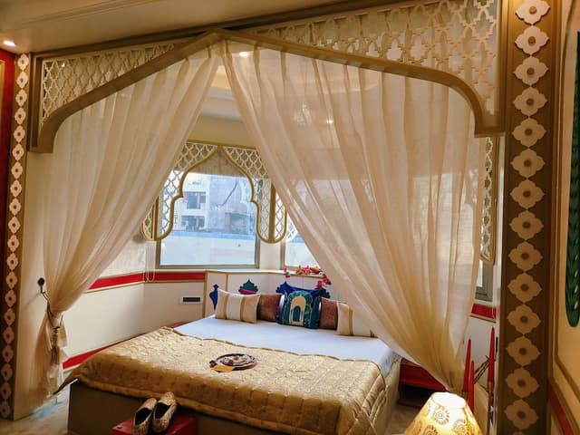 Mughal heritage room with 180 degree city view from Designer bed