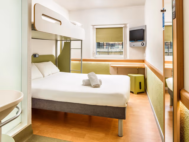 Triple - Room with a large bed and a bunk bed.