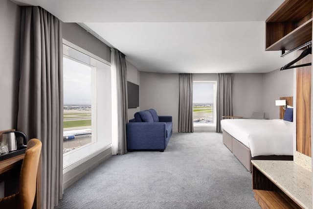 KING FAMILY ROOM WITH RUN WAY VIEW